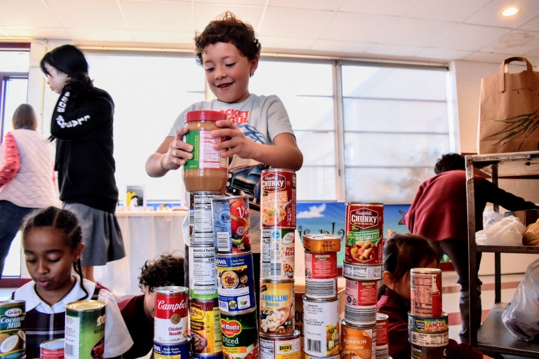 Students organize canned food collected for St Stephens Food Pantry